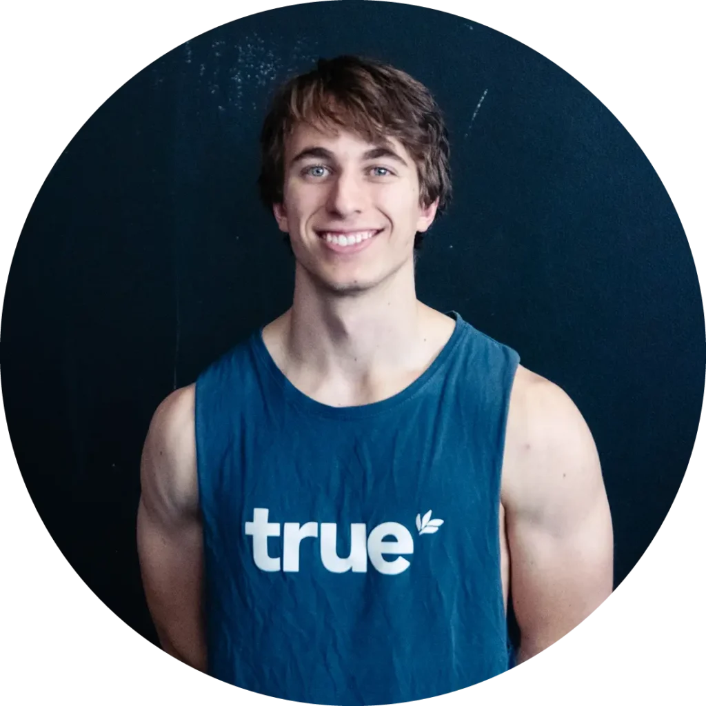 Gym instructor Cameron wearing blue gym top & smiling